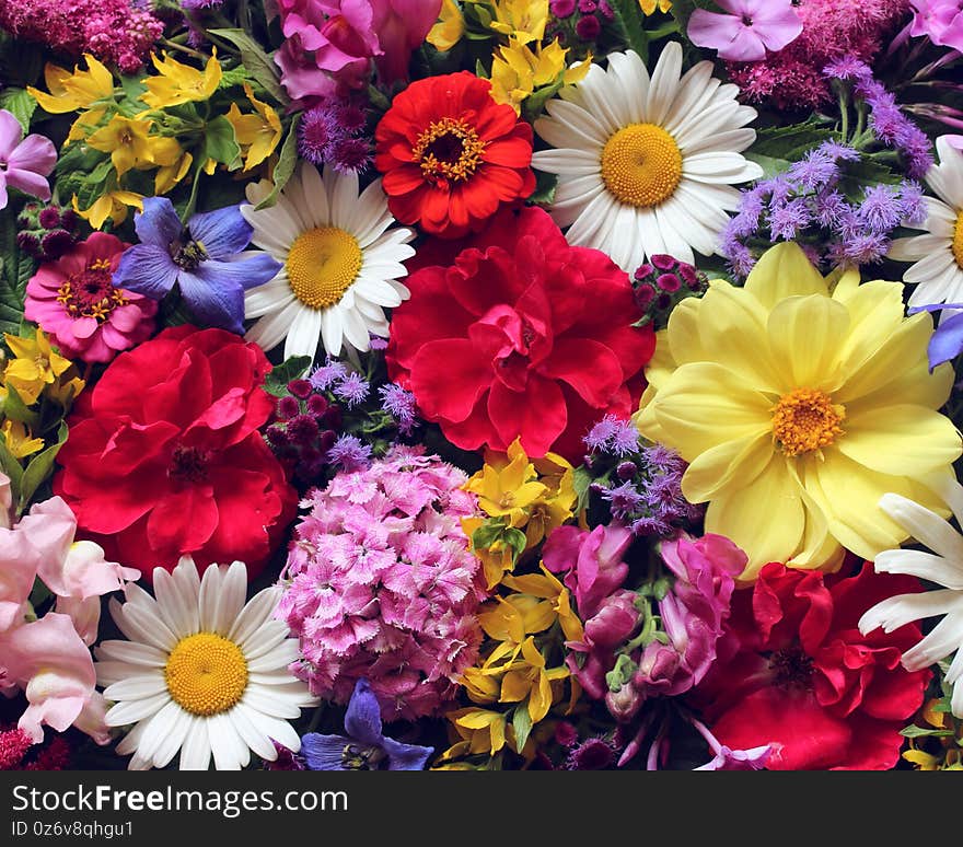 Beautiful floral background, top view. bouquet of garden flowers. roses, dahlias, daisies and other flowers