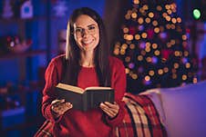 Photo Portrait Of Woman Reading Book Holding In Two Hands Indoors Stock Image