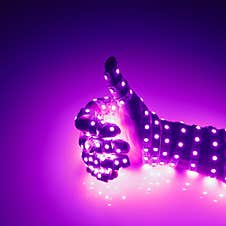 Thumbs Up Hand Covered With Purple Led Lights, Illuminated Background Stock Image