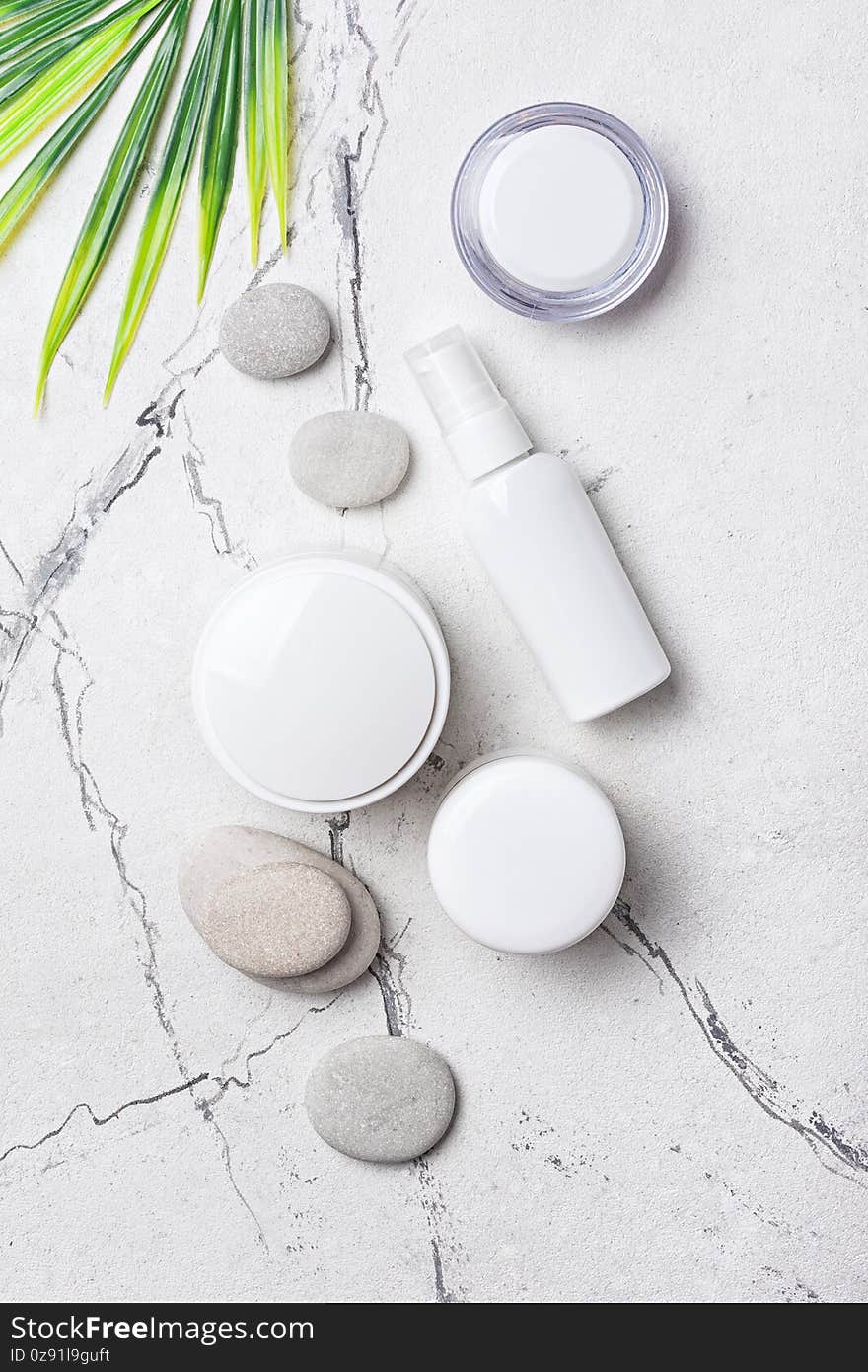 Spa background with cosmetic product and sea stones on white