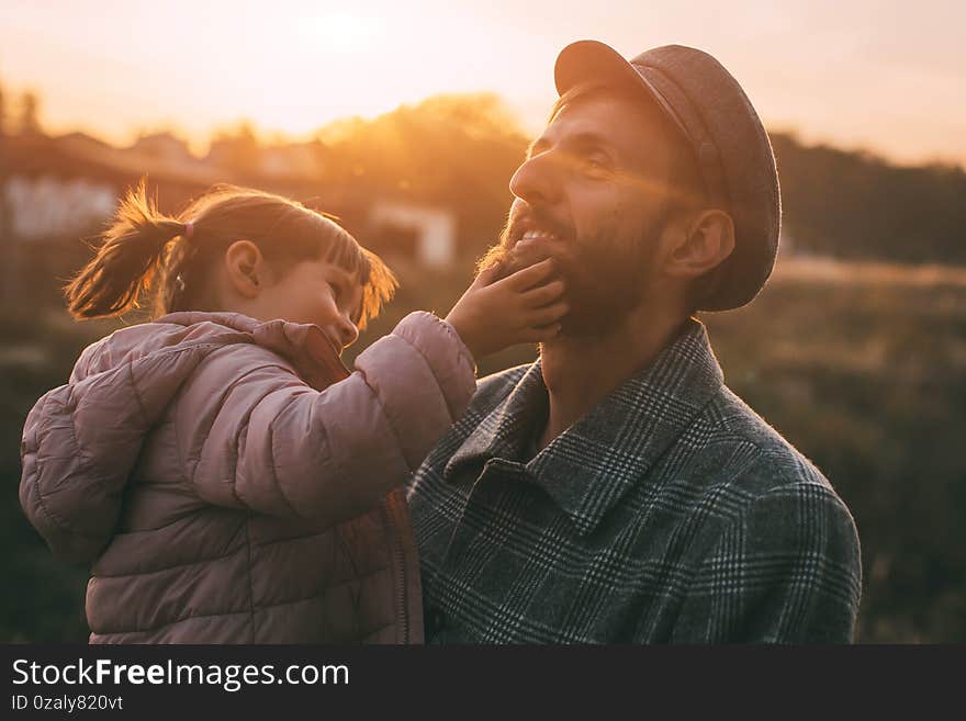 Portrait Of Dad And Daughter At Sunset On A Warm Autumn Day, Beautiful Light And Sunset