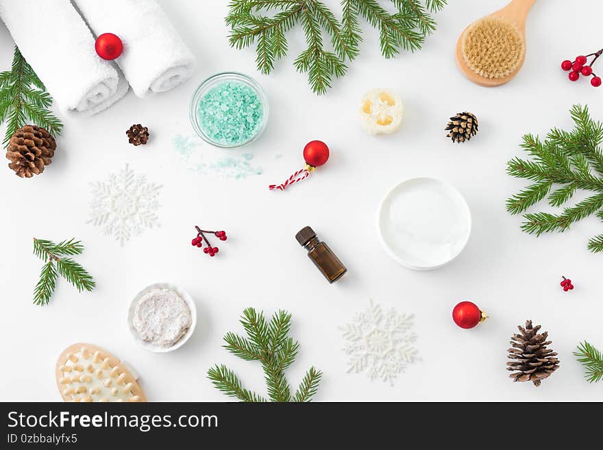 Christmas Spa Concept and Winter Skin Care products, fir branches and snowflakes on white background, flat lay, copy space.  Seasonal beauty routine and body care concept