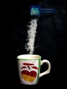 Coffee Cup And Pouring Sugar Spoon Stock Image