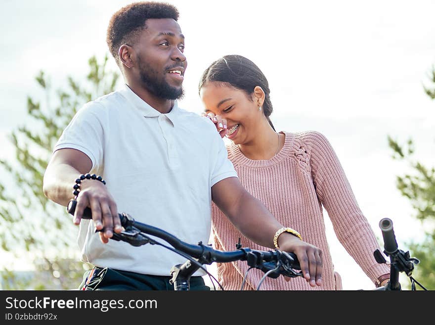 Vietnamese woman and african american man taking a bike for rent