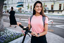 Young Beautiful Woman Riding An Electric Scooter. Royalty Free Stock Photos