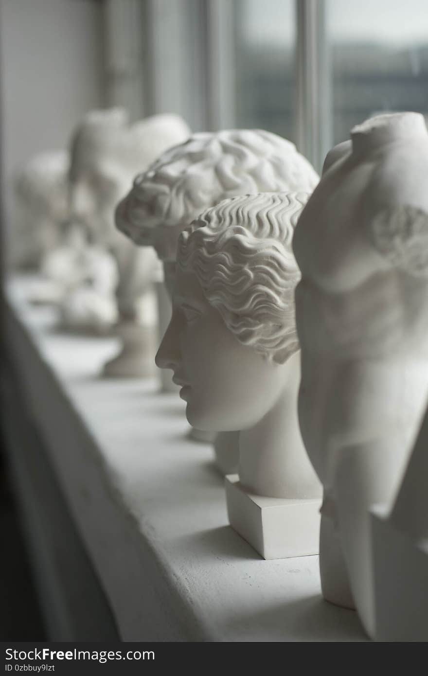 White plaster sculptures stand on the windowsill