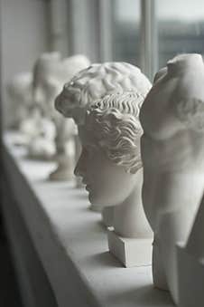 White Plaster Sculptures Stand On The Windowsill Stock Photo