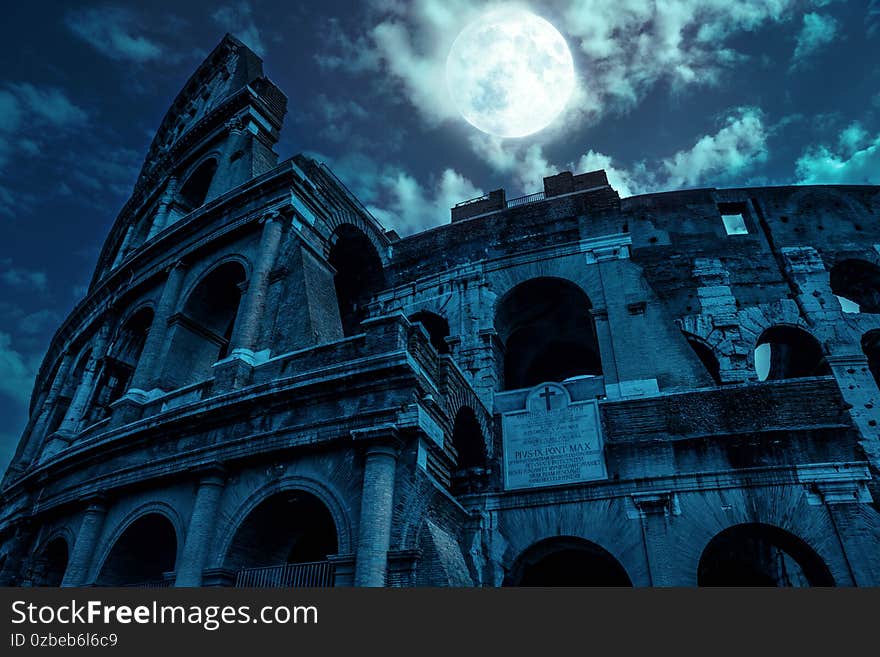 Colosseum at night, Rome, Italy. Mystery creepy view of Ancient Coliseum in full moon