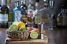 Detail Of The Bar Counter With Some Fruits In A Wicker Basket, Knife And Drink Dispenser. Blurred Background, Copy Space Royalty Free Stock Photo