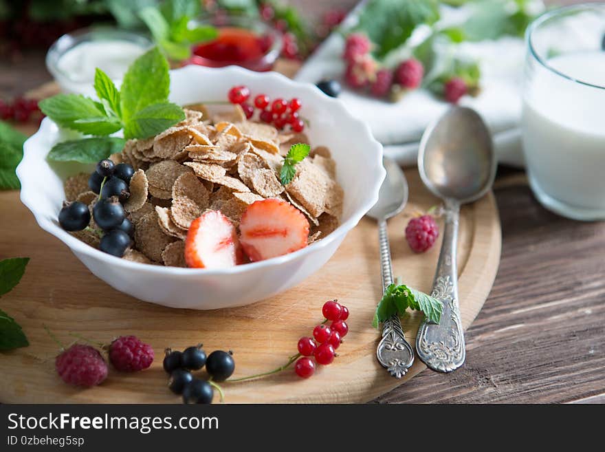 Breakfast Cereal, Table setting. Healthy tasty breakfast multigrain wholewheat healthy cereals with strawberries, raspberries, black currants and red currants.