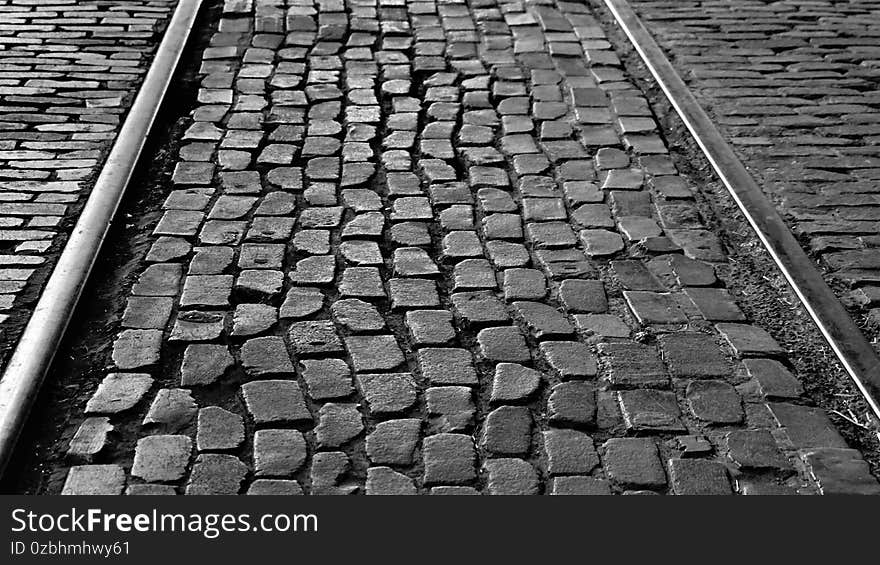 A photograph of the paver stones at the Fort Worth Stock Yards in Fort Worth Texas showing the rail road tracks and old brick and pavers. A photograph of the paver stones at the Fort Worth Stock Yards in Fort Worth Texas showing the rail road tracks and old brick and pavers.