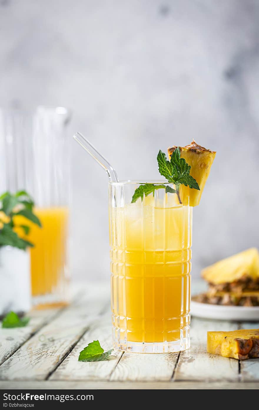 Fresh pineapple cocktail in the glass with ice and mint, summer drink