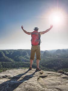 Happy Hiker With Red Backpack Raised Hands On Rock Royalty Free Stock Photo