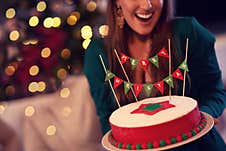 Midsection Of Woman Holding Christmas Cake Stock Photo