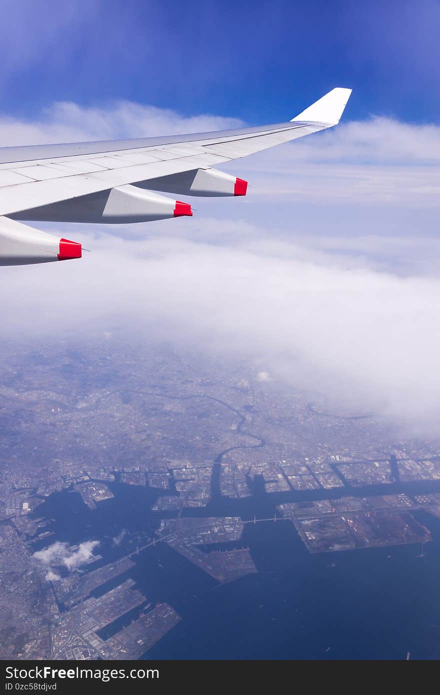 Aerial view of Tokyo-Kawasaki Industrial zone area, Japan from window airplane with city / sea background, Tokyo-Kawasaki, Japan