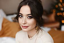 Close Portrait Of An Adult Woman With Bright Evening Makeup With Festive Lights In The Background Stock Photography