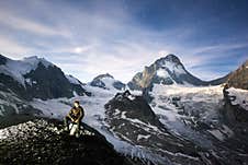 Scenery Of Mountains, Man Sitting On Stone. Royalty Free Stock Image