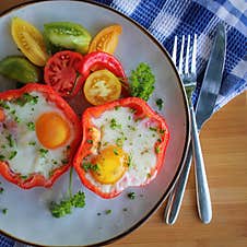 Fried Egg In The Ring Of The Bell Peppers With Herbs Stock Photo