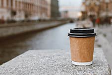 Paper Cup Of Natural Coffee On Bridge Near Of River In St. Petersburg, Copy Space Stock Photography