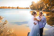 Newlyweds Are Stand On The Shore Of A Picturesque Lake Stock Image