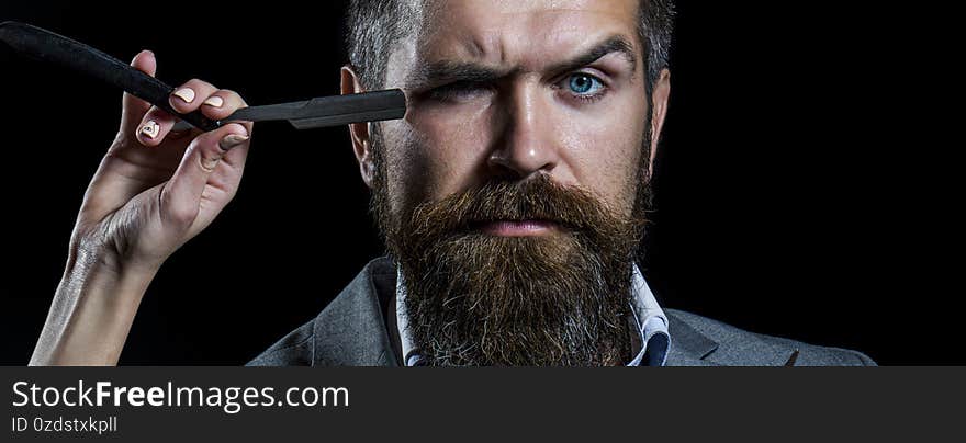 Brutal guy, straight razor. Bearded client visiting barber shop. Barber straight razor, barber shop, suit. Vintage barber shop, shaving. Portrait bearded man. Vintage barbershop.