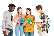 Multicultural Teenagers With Laptop, Books And Royalty Free Stock Photography