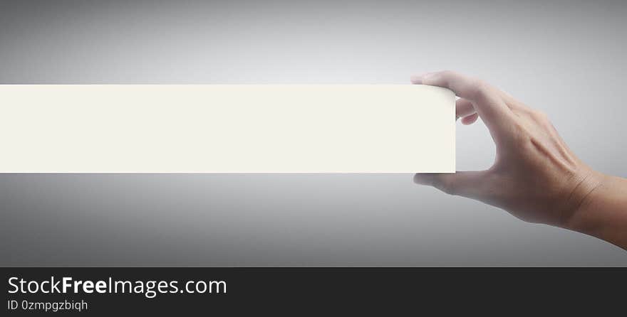 Close up hand holding a paper blank