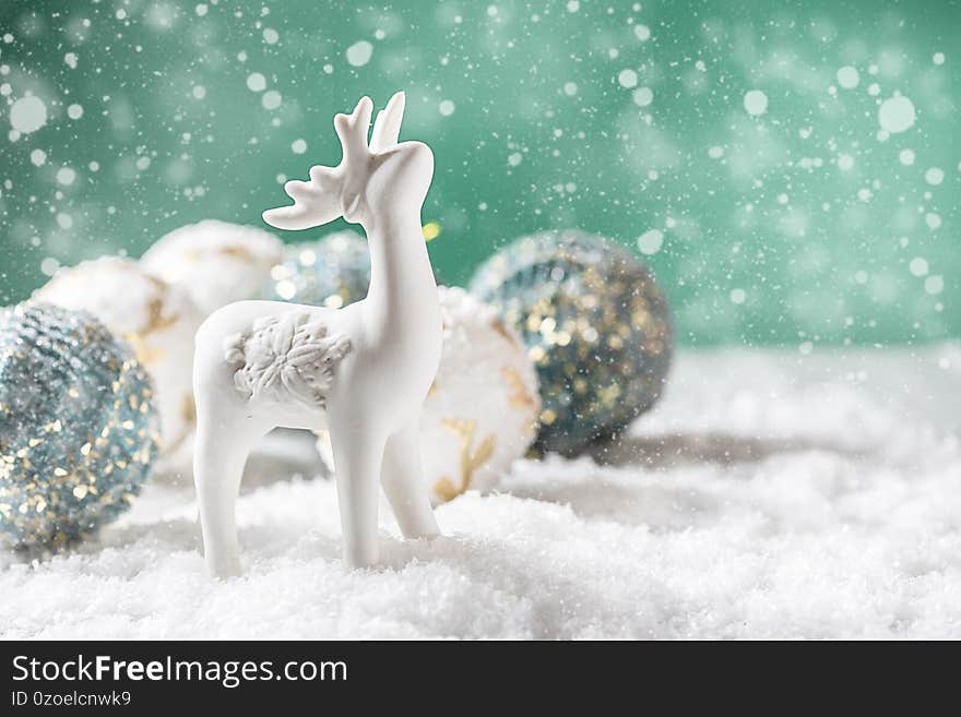 Christmas festive background. Deer and Christmas decoration in snow. Xmas and Happy New Year theme. Copy space