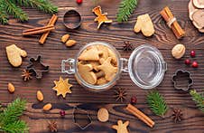 Glass Jar With Gingerbread Among Nuts And Cookie Cutters And Fir Branches Stock Photos