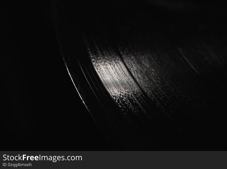 Vinyl record on a black background macro photo.