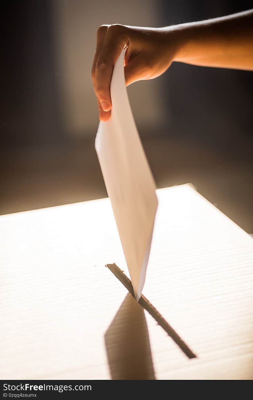 Conceptual image of a person voting, casting a ballot at a polling station, during elections. Conceptual image of a person voting, casting a ballot at a polling station, during elections