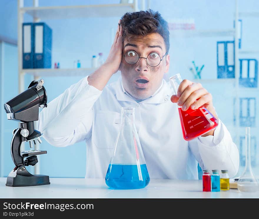 Funny mad chemist working in a laboratory