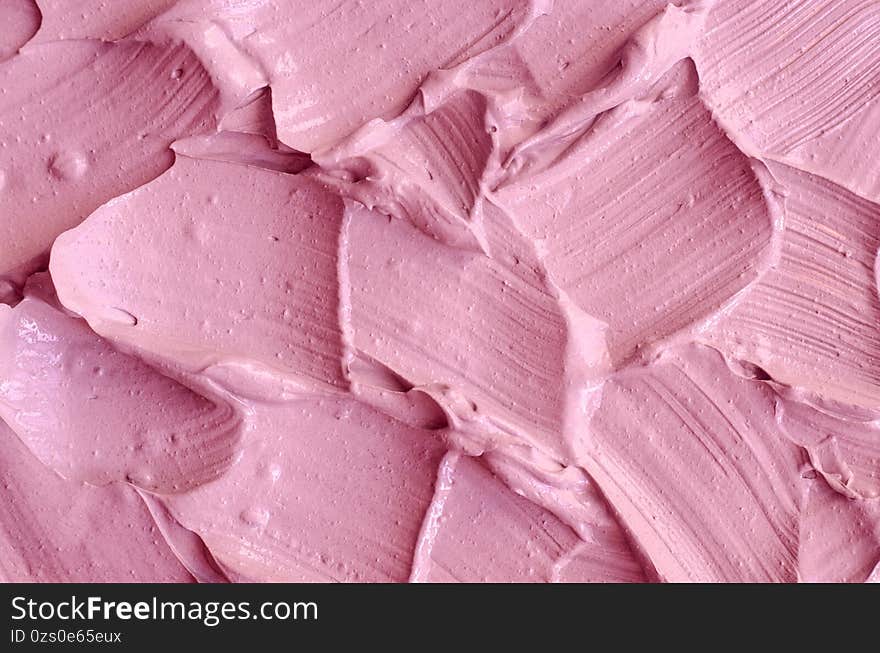 Pale pink cosmetic clay alginate facial mask, face cream, body wrap texture close up, selective focus. Abstract background with brush strokes