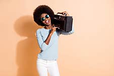 Photo Portrait Of African American Girl Pressing Play On Boom-box Isolated On Pastel Beige Colored Background Stock Photography