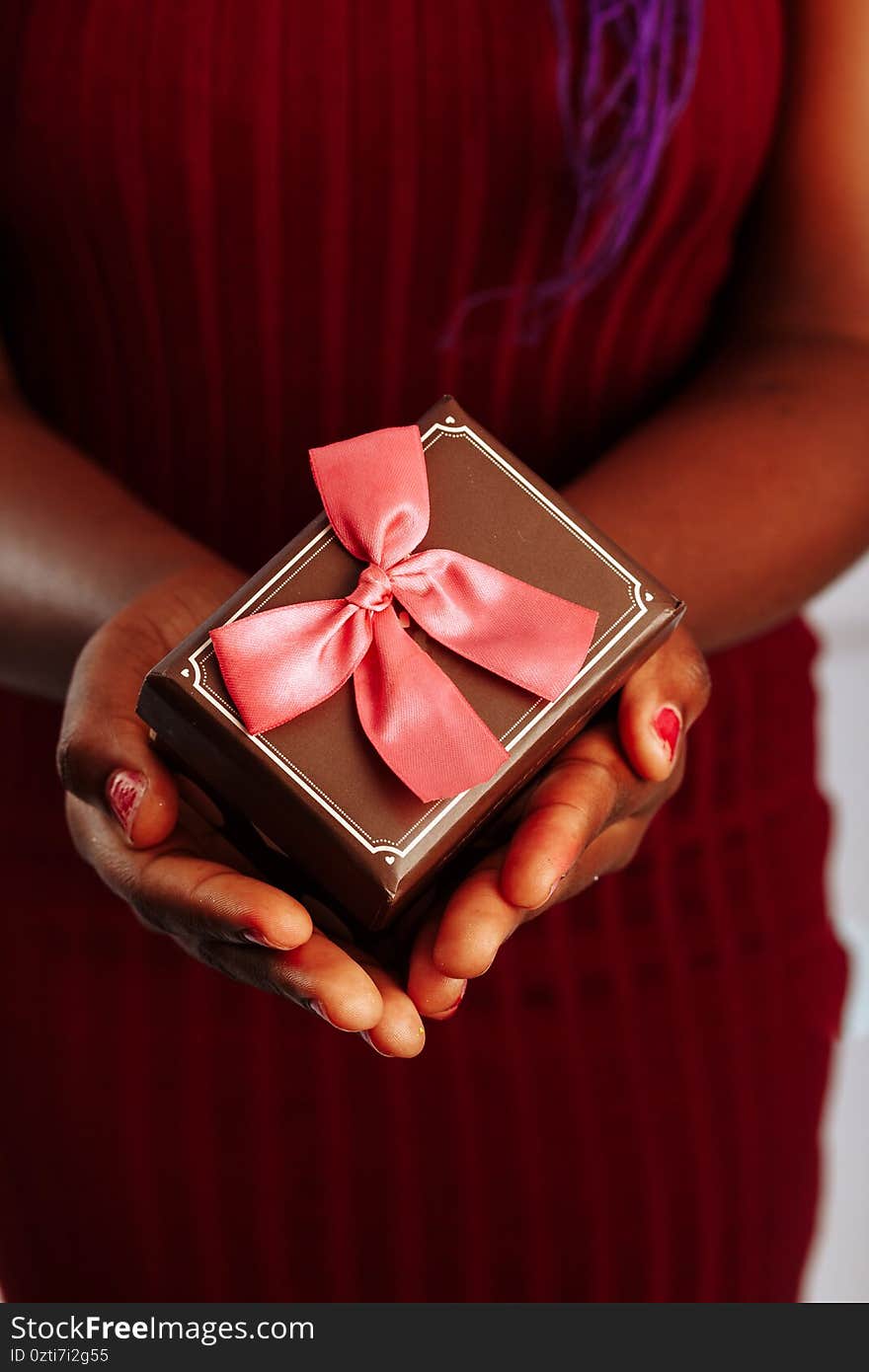 Close up view of hands are giving a beautiful gift box to you, female giving gift, presents and greeting season concept..