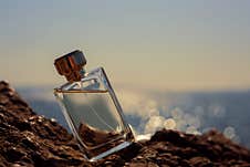 Perfume Bottle On The Background Of The Sea Royalty Free Stock Photography