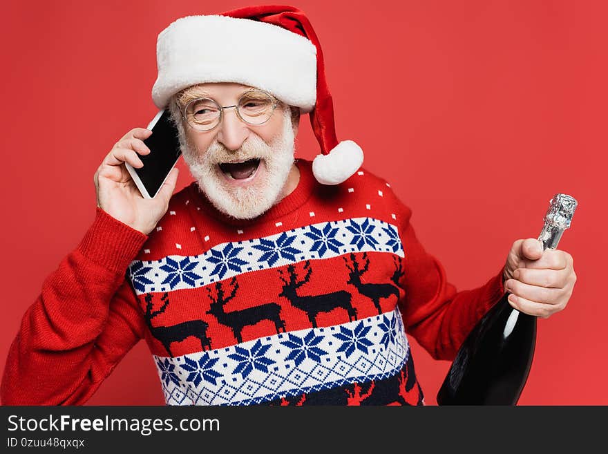 Senior man in santa hat talking