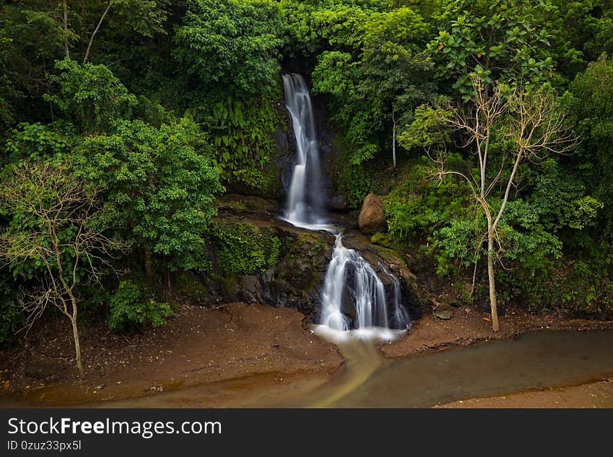 Waterfall landscape. Beautiful waterfall in Ubud. Tropical scenery. Slow shutter speed, motion photography. Nature background.