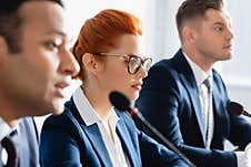 Redhead Female Politician In Eyeglasses, Sitting Stock Photography