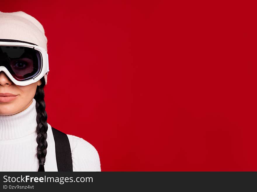 Cropped photo of young happy positive smiling girl wearing goggles on winter vacation isolated on red color background