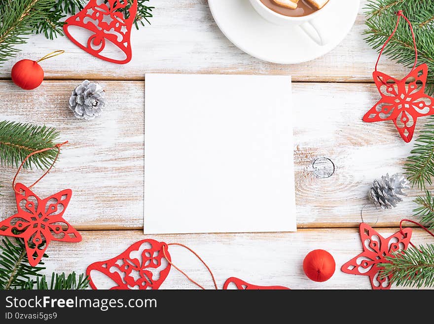 Christmas or New Year frame composition. Decorations, red stars, bells, cones, fir and spruce branches, on a white wooden