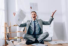 Businessman Throwing Papers While Sitting Near Stock Photos