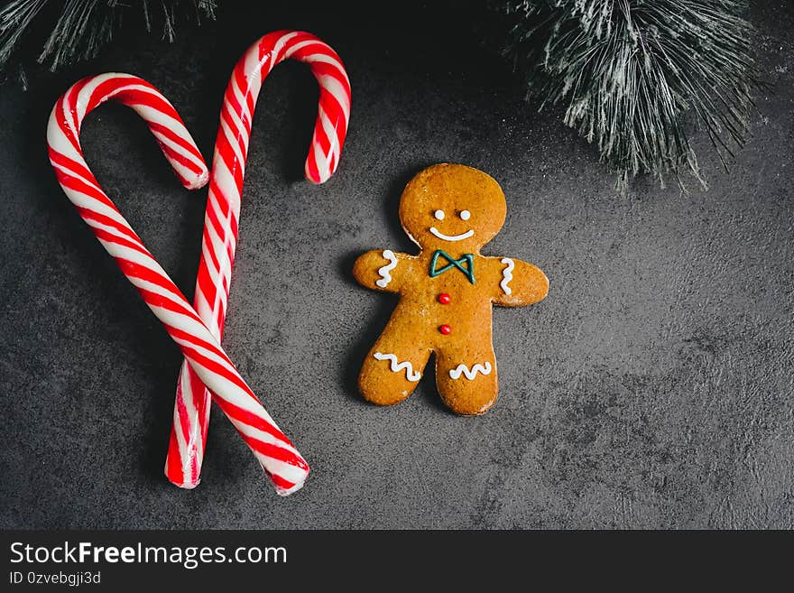 Gingerbread Man. christmas gingerbread cookies on a dark background with candy top view. Candy Snack Sweetness Dessert