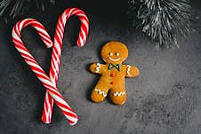 Gingerbread Man. Christmas Gingerbread Cookies On A Dark Background With Candy Top View. Candy Snack Sweetness Dessert Stock Photo