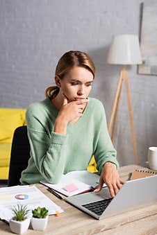 Freelancer Using Laptop While Working Near Royalty Free Stock Photos