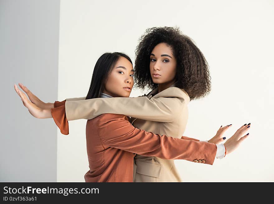 Asian and african american women leaning