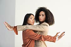 Asian And African American Women Leaning Stock Image