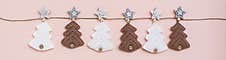 Christmas Handmade. Knitted Fir-trees In A Row On A Rope On A Pastel Background. Handicraft And Leisure. Web Banner Stock Images