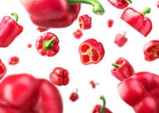 Sweet Red Pepper Sliced And Falling Isolated Stock Photography