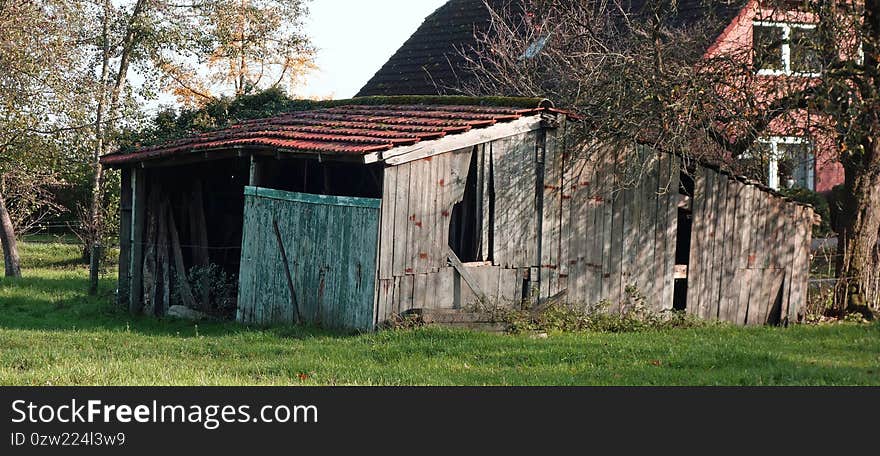 Old shed before a house.